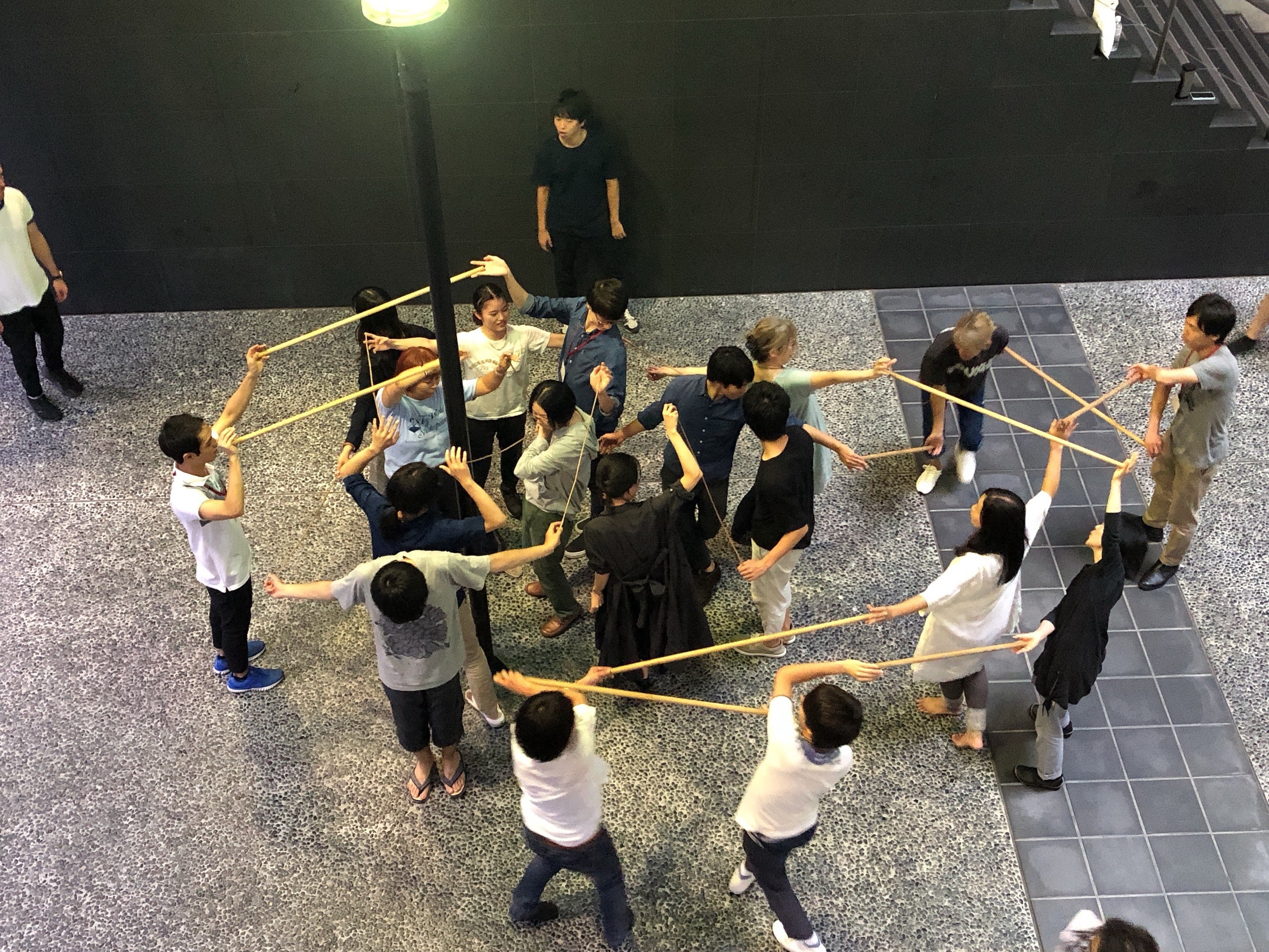 Workshop with attendees playing with group sticks exercise